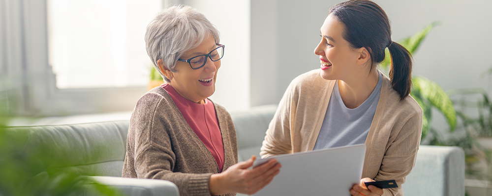 granddaughter helping senior family member with fraud