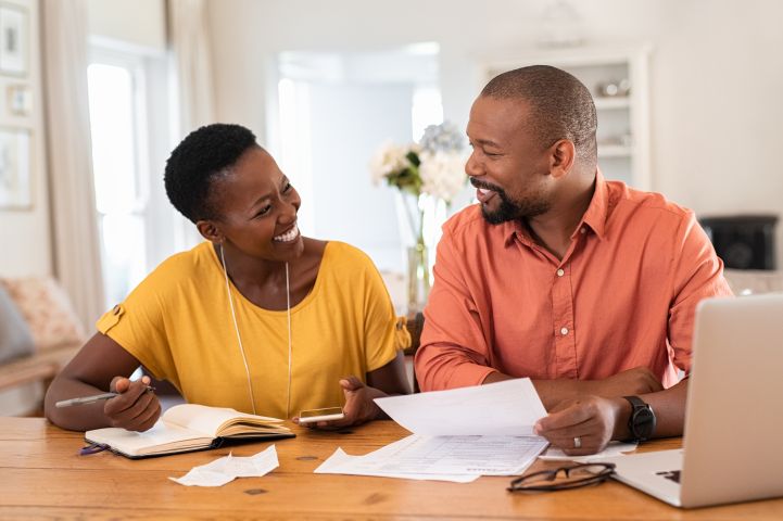 family looking at their finances happy they have wage protector to help cover costs